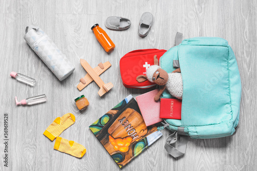Travel accessories for children on wooden background