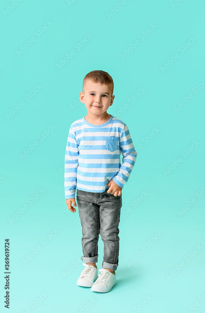 Cute little boy on color background