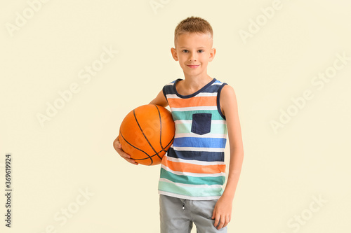 Cute little boy with ball on color background © Pixel-Shot