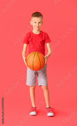 Cute little basketball player on color background © Pixel-Shot
