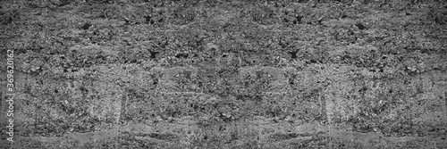 Gray abstract grunge background. Texture of old concrete wall. Wide banner with a rough grungy concrete texture for your design.