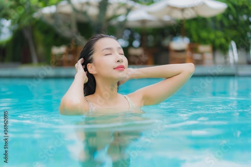 Portrait beautiful young asian woman relax smile around outdoor swimming pool © siraphol