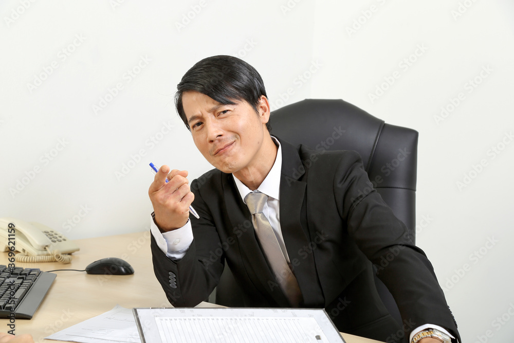 asian man point think sitting at office desk asian man point think sitting at office desk