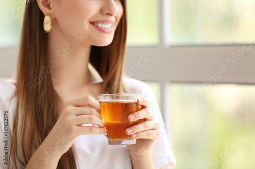 Beautiful young woman drink...
