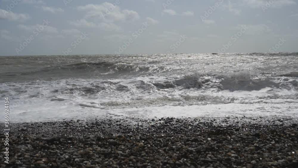 Slow Motion. Ocean waves crushing on a pebble beach. Slow Motion. Ocean waves crushing on a pebble beach.