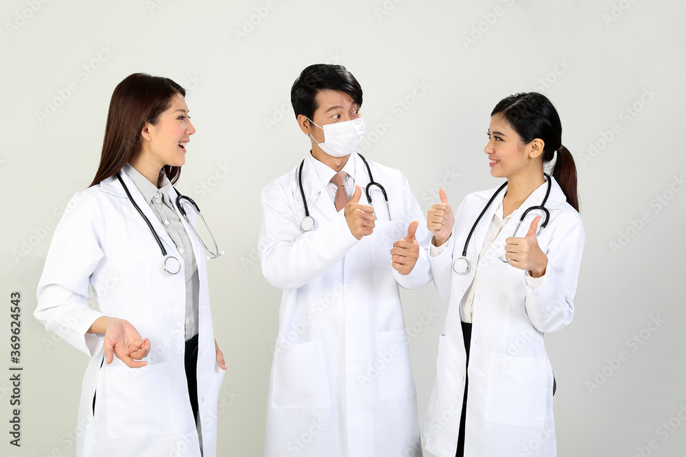 Young Asian male female doctor wearing apron stethoscope thumbs up Young Asian male female doctor wearing apron stethoscope thumbs up