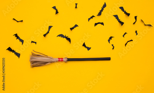 Wallpaper Mural Witch's broomstick, flying bats on yellow background. Halloween handmade decor. Top view. Flat lay Torontodigital.ca