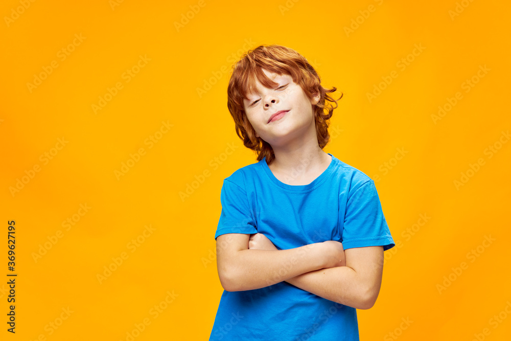 red-haired boy crossed arms and blue t-shirt red-haired boy crossed arms and blue t-shirt