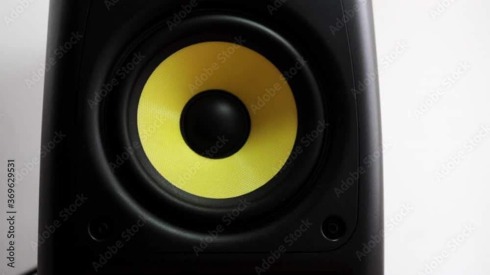 Frontal view close up at vibrating sub-woofer with yellow membrane Frontal view close up at vibrating sub-woofer with yellow membrane