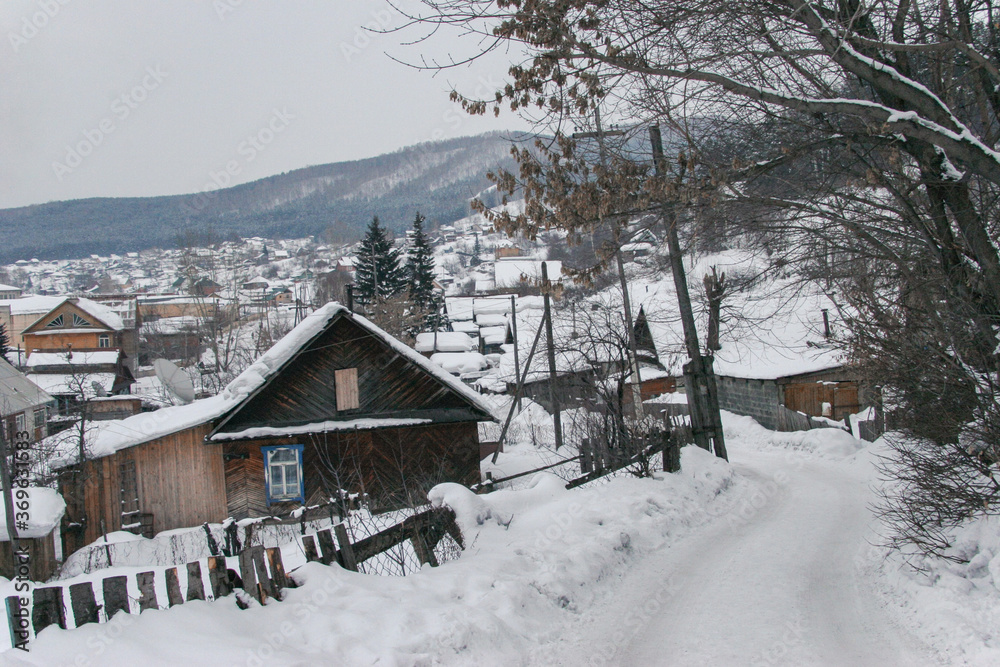 Spring in the Altai Mountains. Snow-covered mountain village. Altai Krai, Russia.