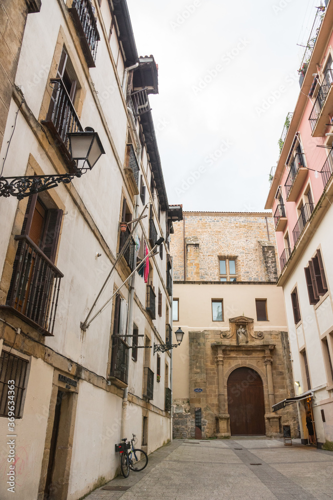 Typical street in the historical old town center of San Sebastian (Donostia, Basque Autonomous Community, Spain). Beautiful architecture. Vertical shot, no tourisyts. 