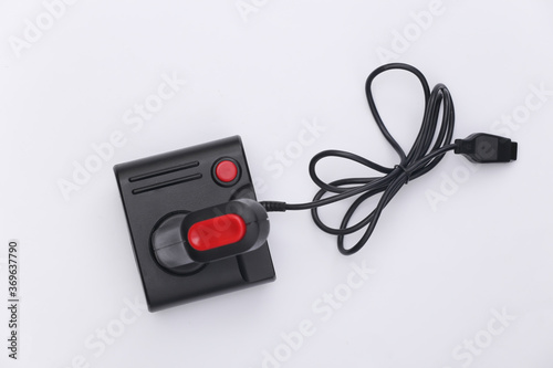 Wired retro joystick with wound cable on white background. Video game, gaming. Top view