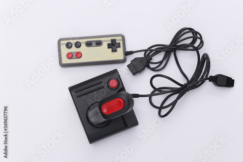 Wired retro gamepad and joystick with wound cable on white background. Video game, gaming. Top view