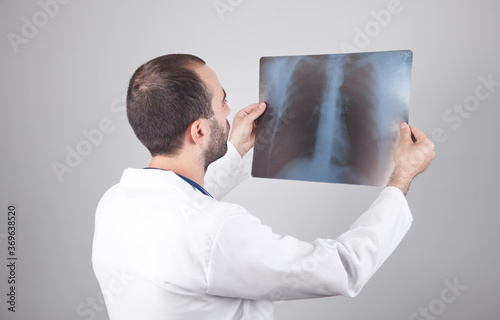 Caucasian doctor looking at xray. Lungs examination