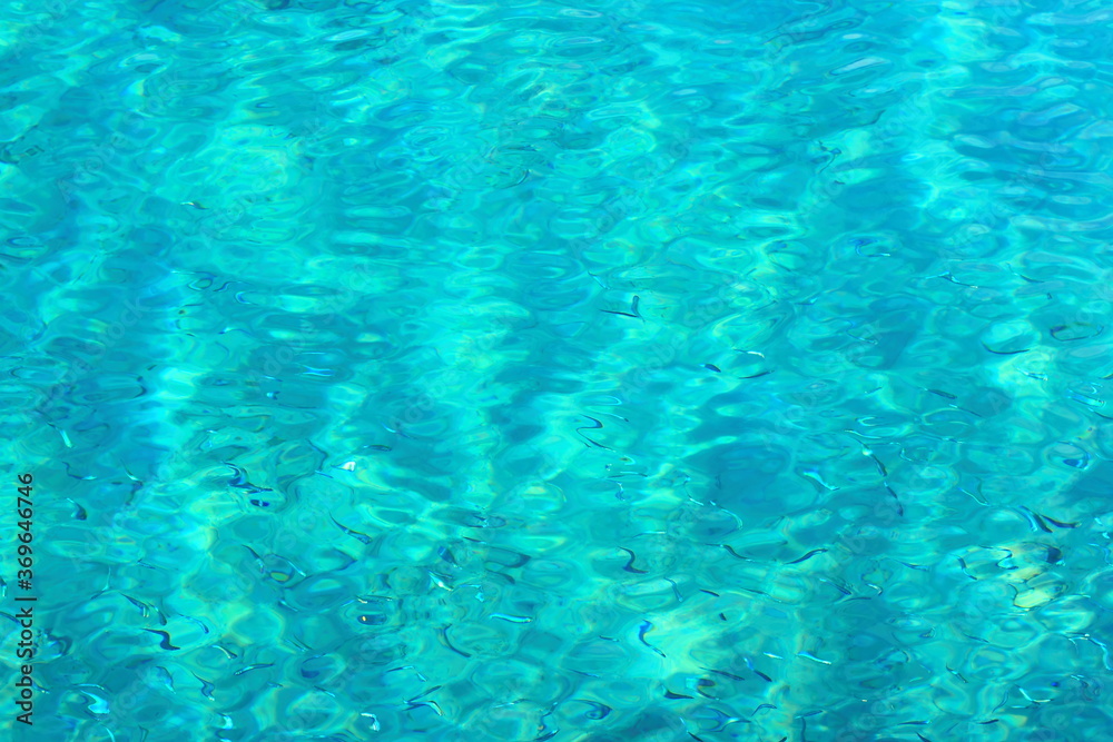 Blurred texture of sea turquoise water with highlights. Soft focus. Blank for designer
