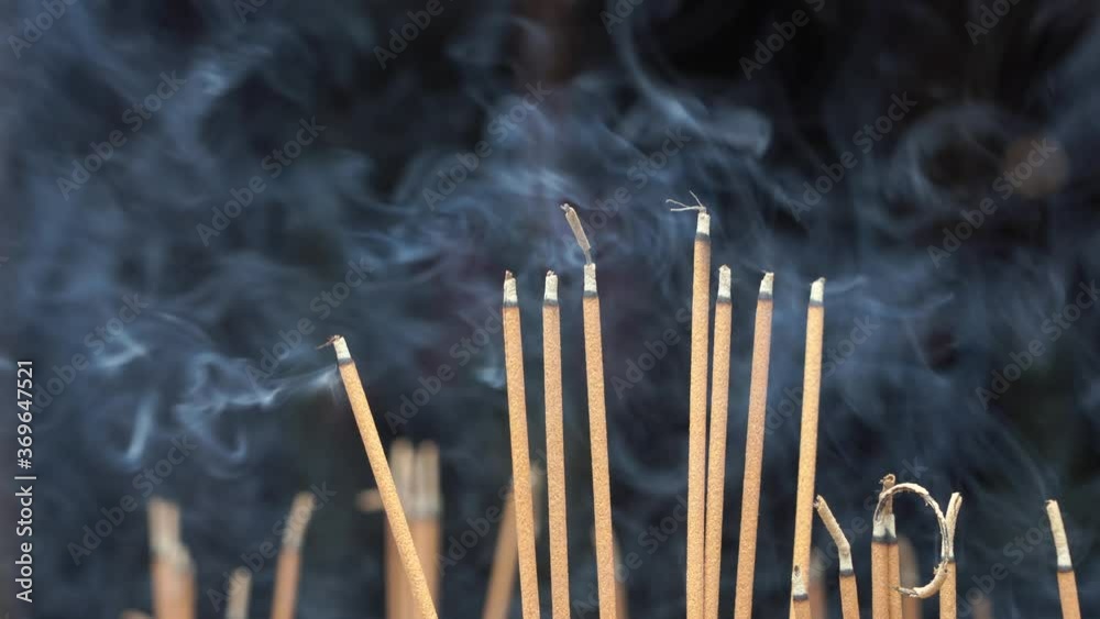 Close-up of incense sticks burning with smoke in buddhist temple of Danang city, Vietnam Close-up of incense sticks burning with smoke in buddhist temple of Danang city, Vietnam