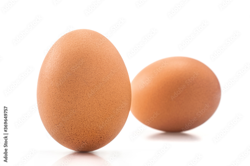 Two Brown chicken eggs isolated on white background. Two Brown chicken eggs isolated on white background.