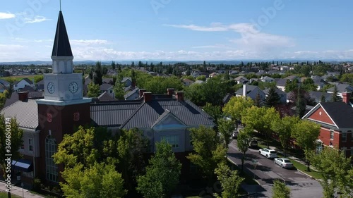 iconic aerial flyby over bricked vintage clock tower of mackenzie towne calgary replica of Inverness overseas UK on a sunny afternoon in Canada Alberta photo