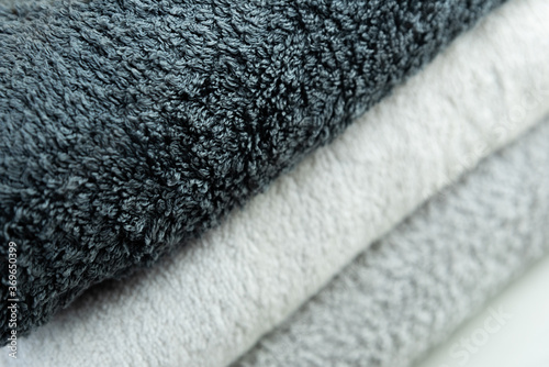 Background of the detail of a terrycloth towels in different shades of gray and white.