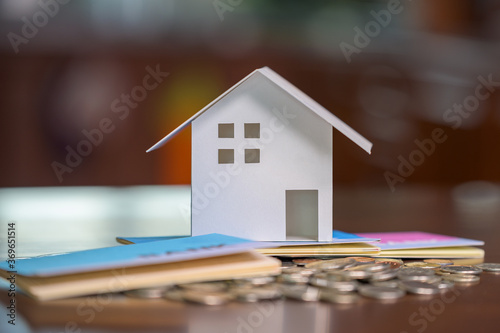 Model houses and stacked coins. Home equity loans. Mortgages and loans.