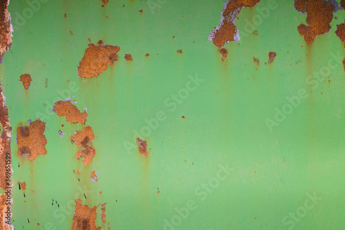 the texture of rusty tin, with already peeled and faded green paint. photo