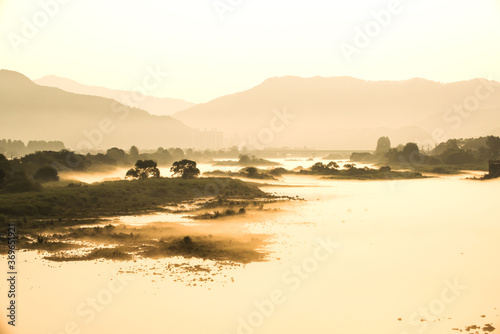 Fantastic landscape of foggy and mist riveside  photo