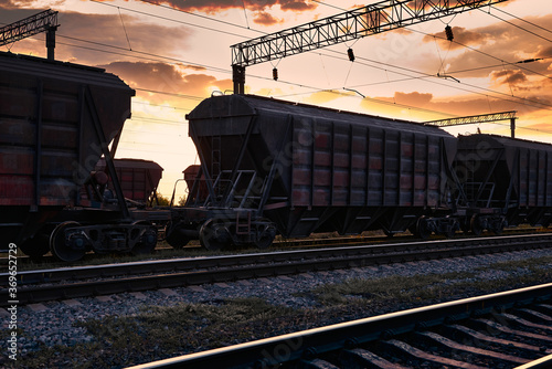 railway and rail cars in a beautiful sunset, dramatic sky and sunlight