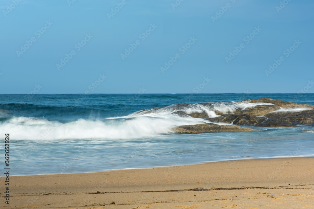 The big breaking waves during a strom at the beautiful summer sea shore background the blue sky and horizon