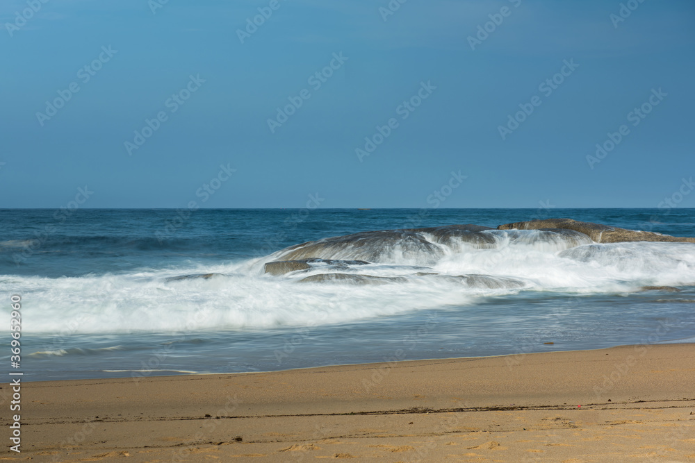 The big breaking waves during a strom at the beautiful summer sea shore background the blue sky and horizon