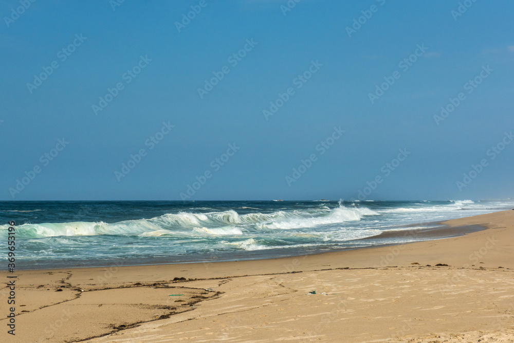 The big breaking waves during a strom at the beautiful summer sea shore background the blue sky and horizon