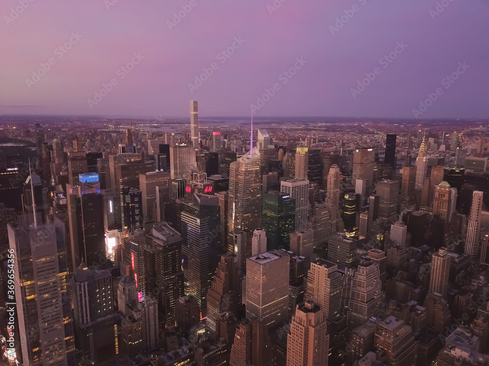 Aerial View of the heart of Manhattan, New York City with Tall Skyscrapers right After Sunset in Dusk light