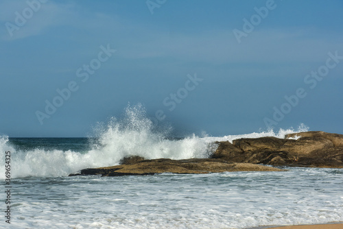 The big breaking waves during a strom at the beautiful summer sea shore background the blue sky and horizon