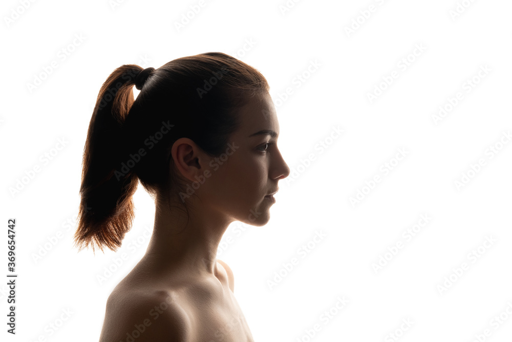 Silhouette portrait. Natural beauty. Woman sideways isolated on white. Skin and body care perfection. Careful cleansing. Neutral makeup