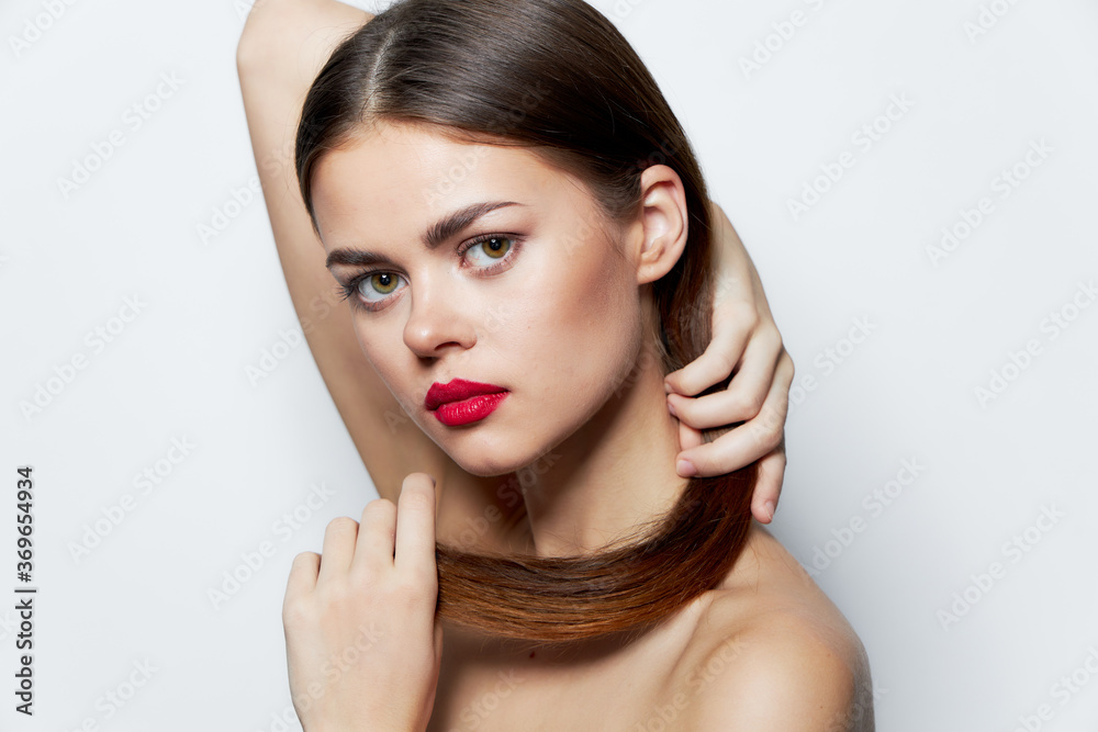 Attractive woman Bare shoulders Attractive look red lips holding hair clear skin Attractive woman Bare shoulders Attractive look red lips holding hair clear skin