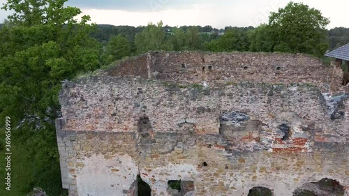 Medieval Castle Ruins in Latvia Rauna.  Aerial View Over Old Stoune Brick Wall of Raunas Castle Where Was Living Archbishop in Middle Age in Latvia. Dron 4k Video photo