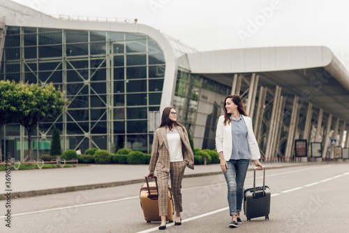 Fotografie Two female co-workers returning from a joint business trip
