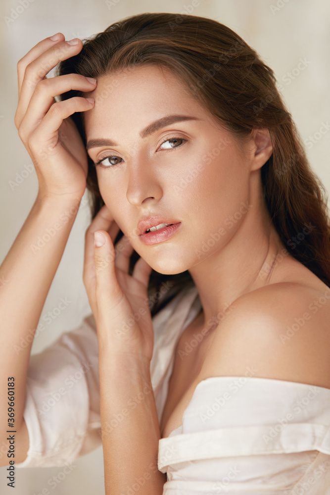Woman. Beauty Portrait Of Young Model Touching Face. Beautiful Brunette With Natural Makeup And Perfect Skin Looking Aside. Woman. Beauty Portrait Of Young Model Touching Face. Beautiful Brunette With Natural Makeup And Perfect Skin Looking Aside.