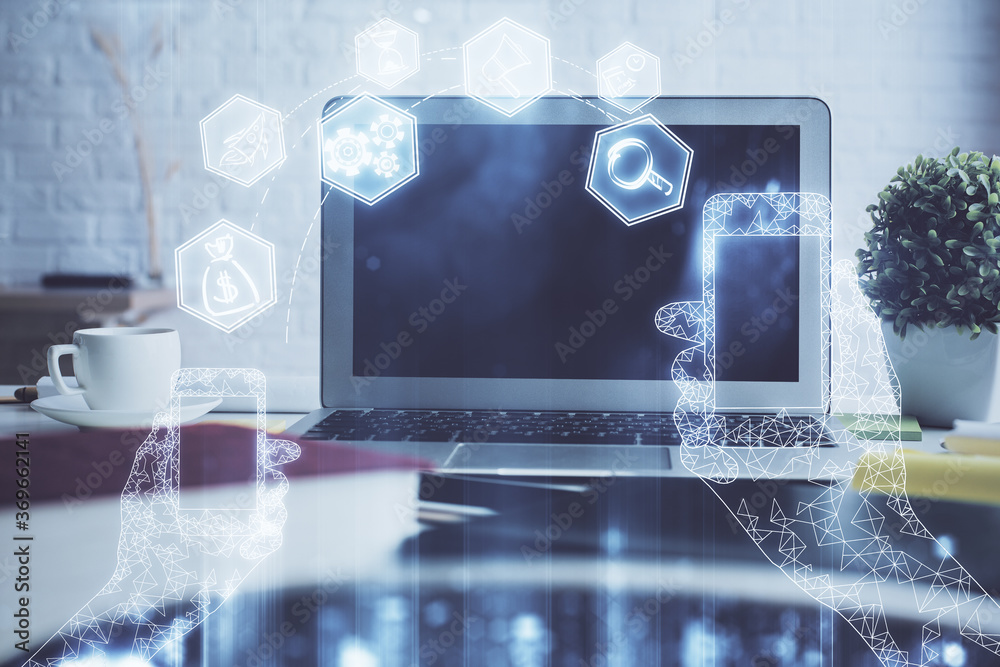 Fototapeta premium Computer on desktop in office with technology theme hologram. Double exposure. Tech concept.
