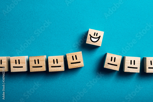 Happy face standing out from crowd