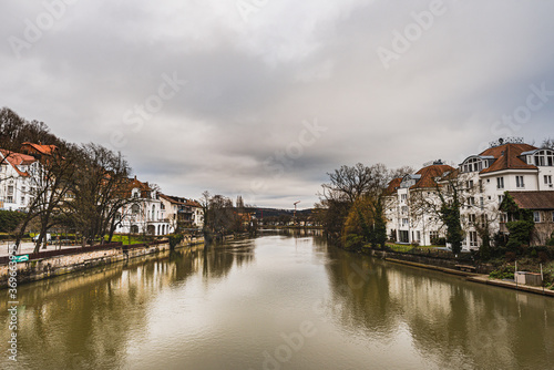 View of the River Neckar with traditional German houses captured from the popular Eberhard Bridge. It reflects how the well off housing community is settled by the river banks - Tubingen, Germany
