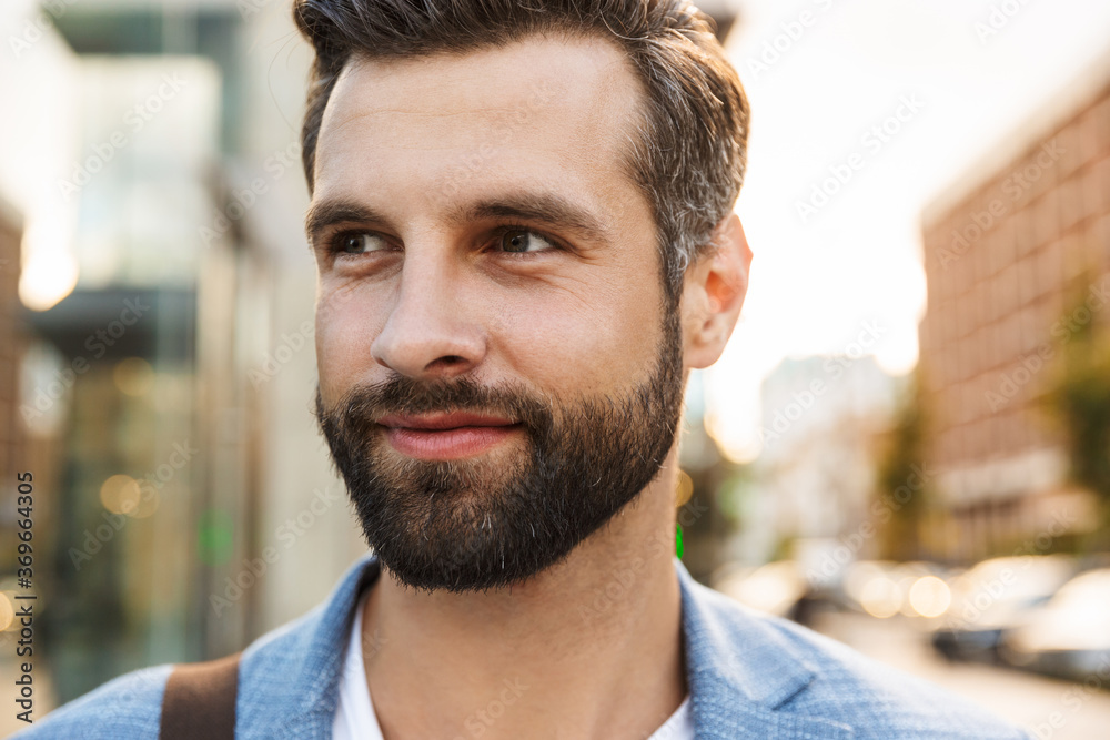 Attractive young bearded man walking outdoors