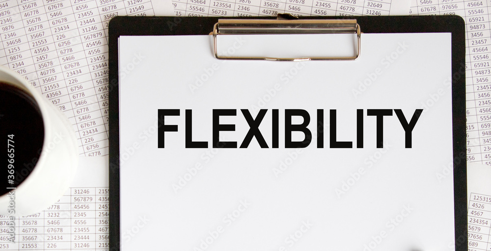 ON the table on the notebook is the inscription FLEXIBILITY, next to glasses and pencils. ON the table on the notebook is the inscription FLEXIBILITY, next to glasses and pencils.
