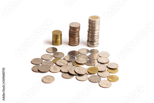 A collection of Thai  baht coins on a white background and clipping path. This coin is denominated in Thai baht. Arrange the coins into a bar chart showing business and financial growth.