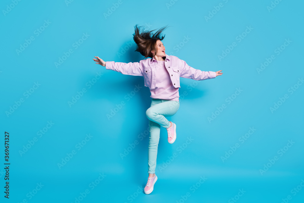 Full body photo of attractive funny lady raise hands leg dancing students party good mood hairdo flight wear casual denim violet jacket sweater pants shoes isolated blue color background