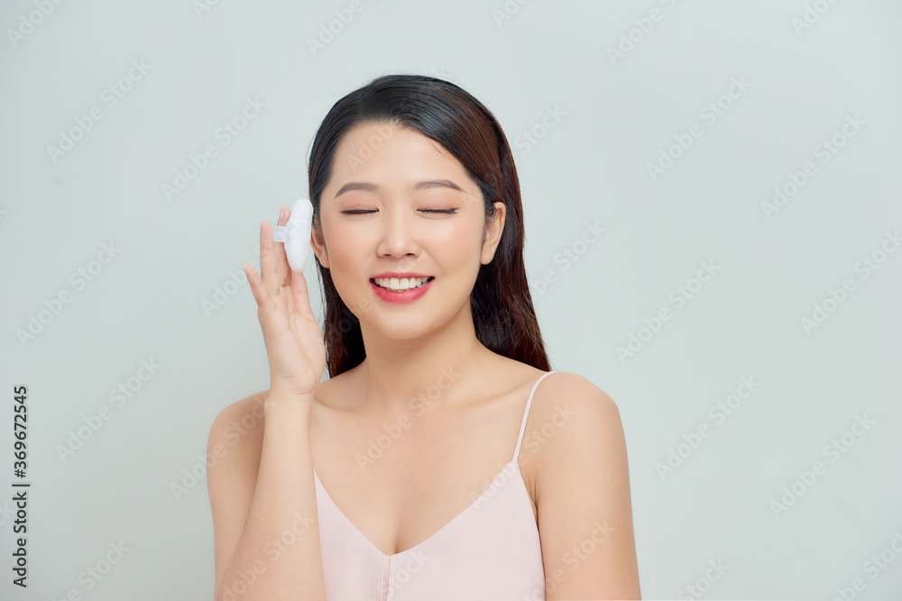 Portrait of young beautiful woman with powder puff. Girl applying makeup. Portrait of young beautiful woman with powder puff. Girl applying makeup.