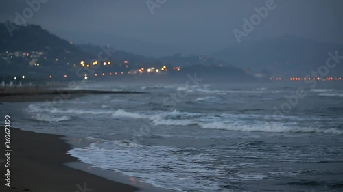 Waves at sea. Storm in the ocean. Italian coast of the Tyrrhenian Sea. Morning twilight with fog.