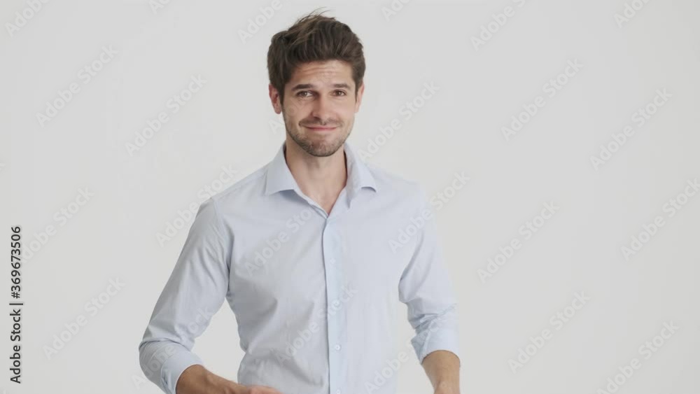 A handsome man is dancing standing isolated over white background A handsome man is dancing standing isolated over white background