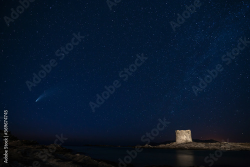 Comet Neowise seen from the La Pelosa beach under the medieval tower, Stintino, Sassari, Sardinia