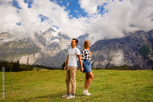 Beautiful couple posing together with mountains in background