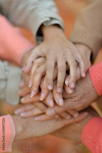 Close-up cropped image, family putting hands together © aletia2011